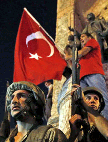 Image of a man holding a Turkish flag behind a squad of armed men